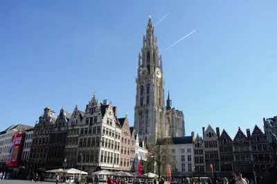 a tall building with a clock tower in a city at Historical center Antwerp, all on foot in Antwerp