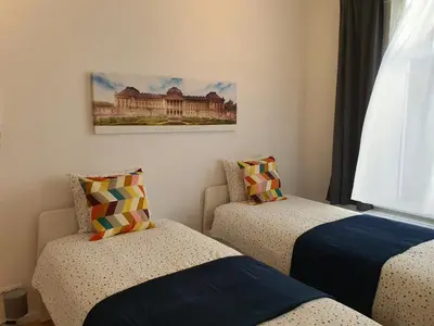 a bedroom with two beds and a picture on the wall at Chez Esmara et Philippe Grand-Place in Brussels