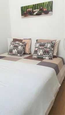 a white bed with two pillows on top of it at Chez Esmara et Philippe Grand-Place in Brussels