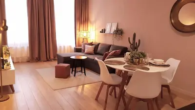a living room with a couch and a table and chairs at BnB Antwerpen - CHARMANT in Antwerp