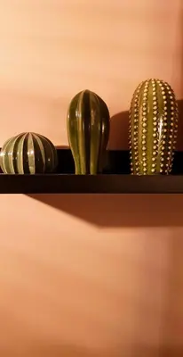 three green vases sitting on a shelf at BnB Antwerpen - CHARMANT in Antwerp