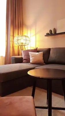 a living room with a couch and a table at BnB Antwerpen - CHARMANT in Antwerp
