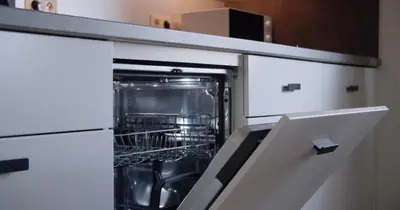 an open dishwasher with its door open in a kitchen at Berkies - autonome studio in Steenokkerzeel