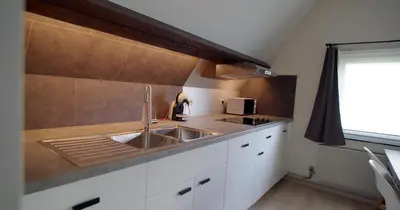 a kitchen with a sink and a counter top at Berkies - autonome studio in Steenokkerzeel