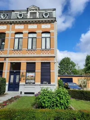 a brick building with a clock on top of it at On our way to Antwerp, first stop in Mortsel