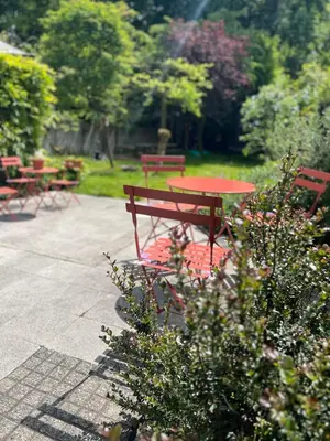 a red picnic table and benches in a park at Maison Georges in Turnhout