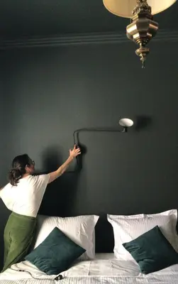 a woman is jumping on top of a bed at Maison Georges in Turnhout