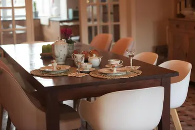 a dining room table with plates and glasses on it at Vakantiehuis huYze-K in Zottegem
