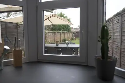 a door leading to a patio with a potted plant at Vakantiehuis huYze-K in Zottegem