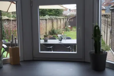 a door leading to a patio with a table outside at Vakantiehuis huYze-K in Zottegem