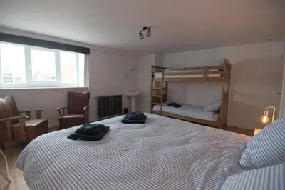 a bedroom with two beds and a bunk bed at Vakantiehuis huYze-K in Zottegem