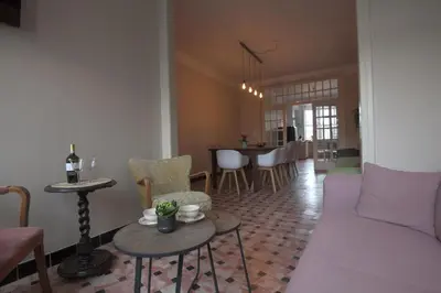 a living room with a couch and a table and chairs at Vakantiehuis huYze-K in Zottegem