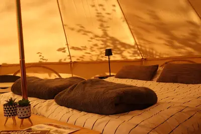 two beds in a room with at Glamping Zonnebloem - Back-to-Nature in Herzele