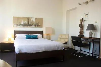 a bedroom with a bed and a desk and a chair at Handy Studio close to Zaventem airport in Brussels