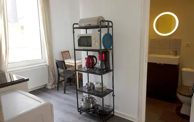 a room with a kitchen with a microwave on a shelf at Handy Studio close to Zaventem airport in Brussels