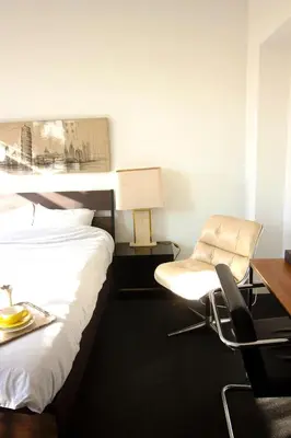 a hotel room with a bed and a desk and a chair at Handy Studio close to Zaventem airport in Brussels