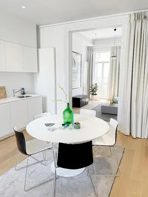 a white dining room with a white table and chairs at Jacob’s Getaway in Ghent