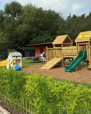 a playground with a slide and a play structure at Le Canard - Rust aan het water in Geel