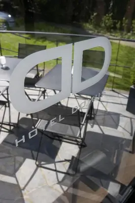 a large white sign sitting on top of a table at Hotel Domus in Boom