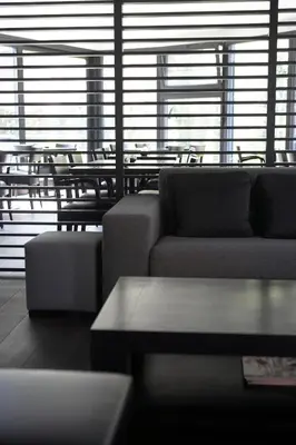 a living room with couches and a table and chairs at Hotel Domus in Boom