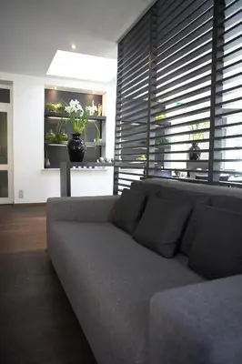 a living room with a couch and a table at Hotel Domus in Boom