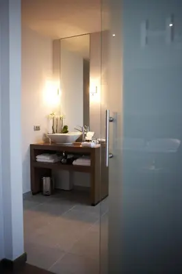 a bathroom with a sink and a mirror at Hotel Domus in Boom