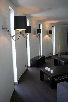 a living room with a couch and a table at Hotel Domus in Boom