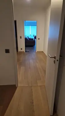 a hallway with a view of a living room at Gezellig appartement Beveren Kruibeke Zwijndrecht Donkvijver in Beveren