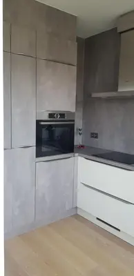 a kitchen with stainless steel cabinets and an oven at Gezellig appartement Beveren Kruibeke Zwijndrecht Donkvijver in Beveren