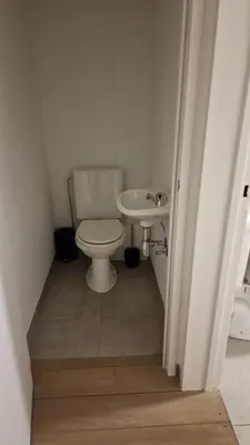 a bathroom with a toilet and a sink at Gezellig appartement Beveren Kruibeke Zwijndrecht Donkvijver in Beveren