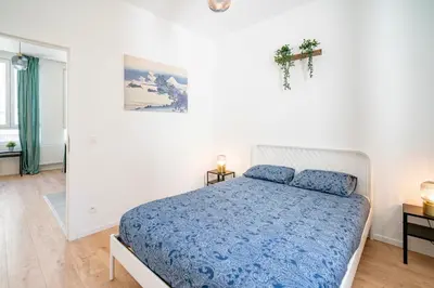 a bedroom with a bed and a cross on the wall at Charming Central Cityflats in Antwerp