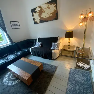 a living room with a couch and a coffee table at Cozy studio close to Zaventem Airport in Brussels