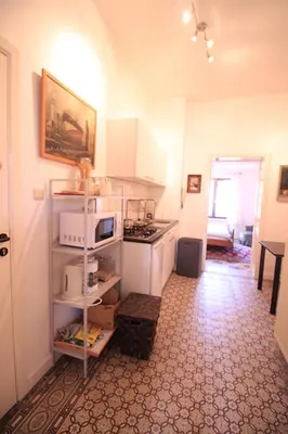 a kitchen with white cabinets and a stove top oven at Cozy studio close to Zaventem Airport in Brussels