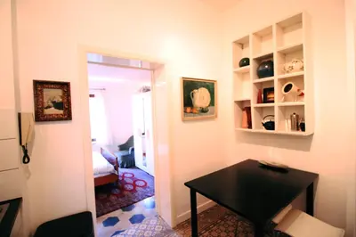 a room with a table and a room with a bedroom at Cozy studio close to Zaventem Airport in Brussels