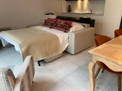 a bedroom with a bed and a table and chairs at Apartment in the Heart of Ghent in Ghent