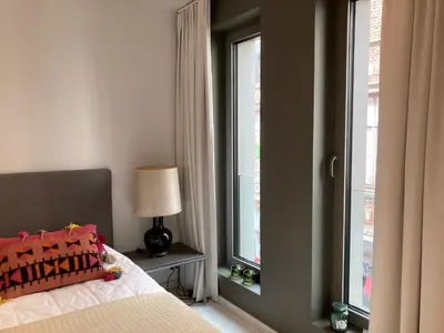 a bedroom with a bed and a window at Apartment in the Heart of Ghent in Ghent