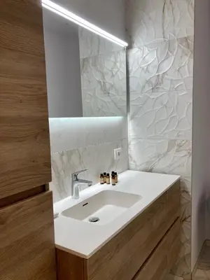a bathroom with a white sink and a mirror at Apartment in the Heart of Ghent in Ghent