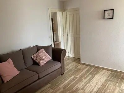 a living room with a brown couch in a room at Rustig appartement in het groen met terras in Kontich