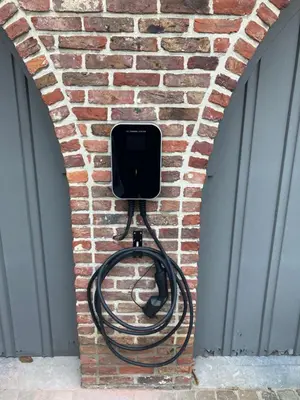 a hose is hooked up to a brick wall at Rustig appartement in het groen met terras in Kontich