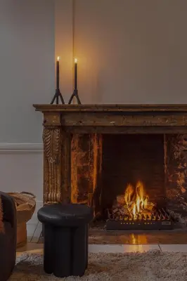 a fireplace with two candles in a living room at LuxuryApartmentSoulforCity in Ghent