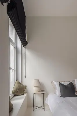 a white bedroom with a bed and a window at LuxuryApartmentSoulforCity in Ghent