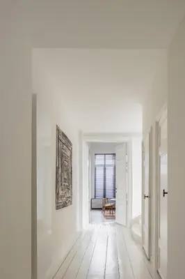 an empty hallway with white walls and wooden floors at LuxuryApartmentSoulforCity in Ghent