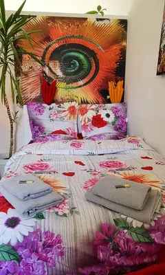 a bedroom with a bed with a painting on the wall at Bright studio close to Zaventem airport in Brussels