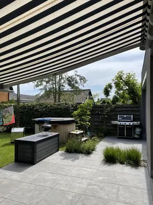 a patio with a table and a grill at Great house 5' from Tomorrowland in Rumst