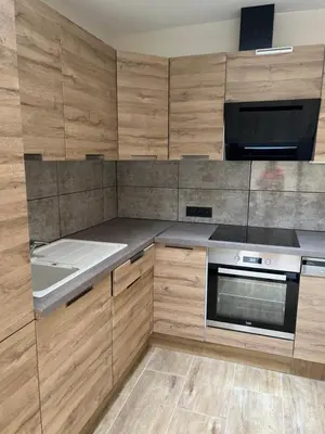 a kitchen with wooden cabinets and a stove top oven at Exclusive two-level apartment with private terrace on the canal Brussels in Brussels