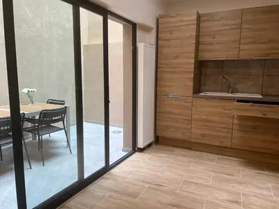 a kitchen with wooden walls and a table with a dining room at Exclusive two-level apartment with private terrace on the canal Brussels in Brussels