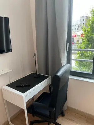 a desk with a chair next to a window at Exclusive two-level apartment with private terrace on the canal Brussels in Brussels