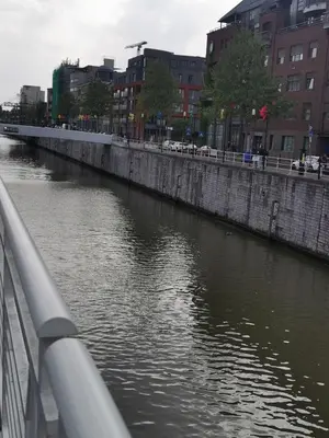 a river in a city with buildings and cars at Exclusive two-level apartment with private terrace on the canal Brussels in Brussels