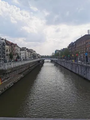 a bridge over a river in a city at Exclusive two-level apartment with private terrace on the canal Brussels in Brussels