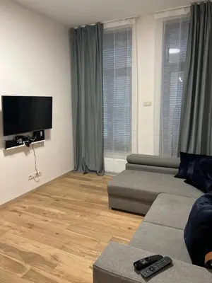 a living room with a couch and a flat screen tv at Exclusive two-level apartment with private terrace on the canal Brussels in Brussels